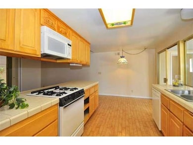 Ample cabinet space in the sunny kitchen with open breakfast nook