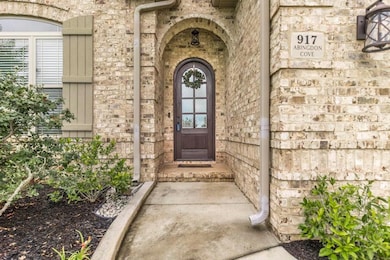 Entrance to property featuring stone siding