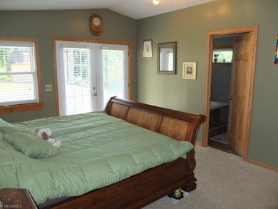 First floor master suite with vaulted ceiling, wal