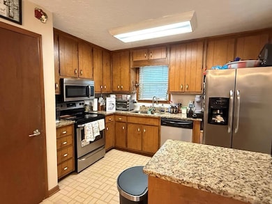 Kitchen featuring stainless steel appliances, a si