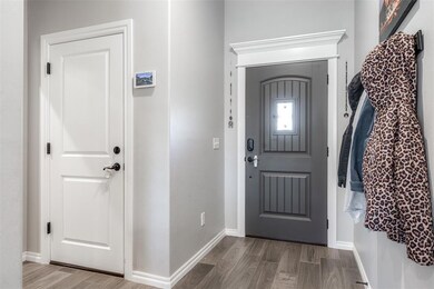 Entrance foyer with hardwood / wood-style floors