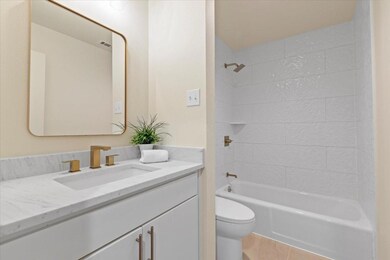 Full bathroom with tile patterned flooring, vanity
