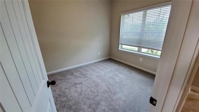 Spare room featuring plenty of natural light and light carpet
