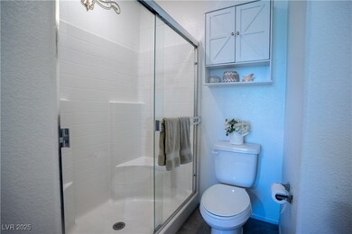 Full bathroom with a textured wall and a stall shower