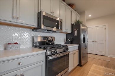Kitchen featuring light stone countertops, white c