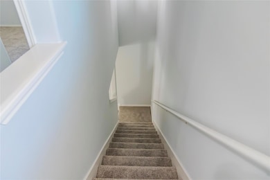 Stairway featuring carpet floors and baseboards