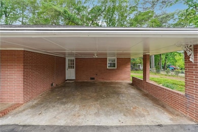 View of patio with a carport