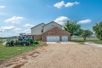 ide view  of house with circle driveway in front