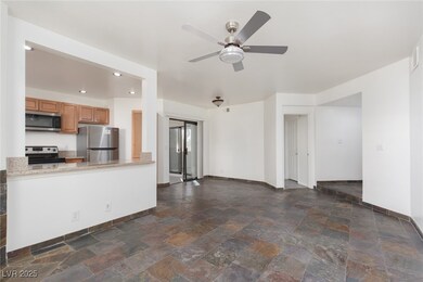 Unfurnished living room with recessed lighting, stone tile floors, and ceiling fan