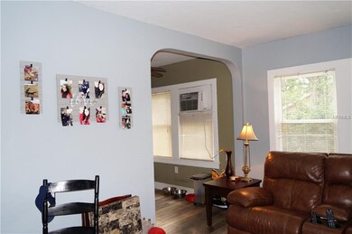 Living room with arched entry to kitchen