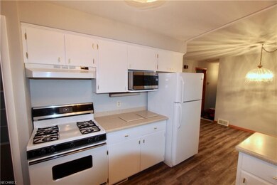 Kitchen features corian counters and a view to the