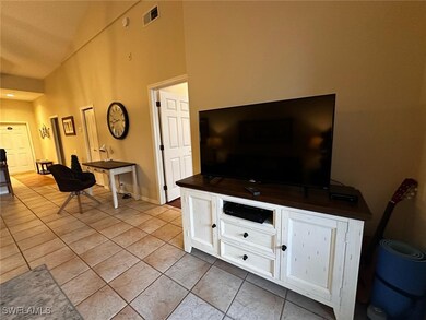 Living area featuring baseboards, visible vents, l