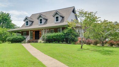 Wonderful rocking chair front porch with wrap around porch on five wonderous private acres with gorgeous pond just minutes to Nolensville Historic District.