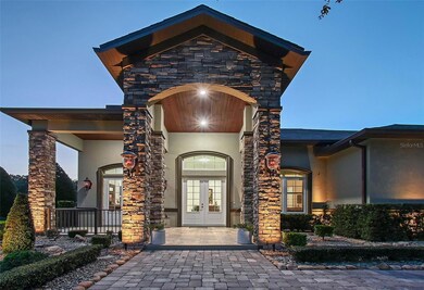 Stunning entryway with landscape lighting throughout the property