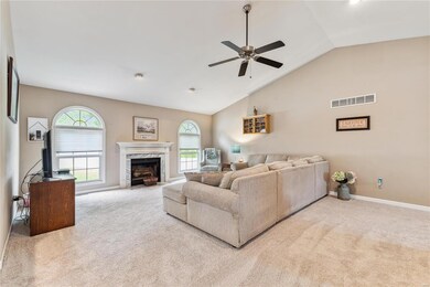 Living room with fire place and abundant light.