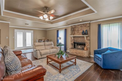 Living room with wood-type flooring, ceiling fan, 