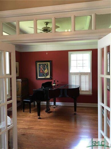Living room with hardwood floors and plantation sh
