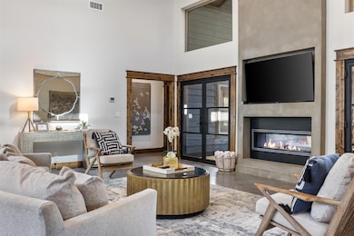 Living room featuring a high ceiling and hardwood 
