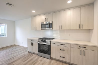 Kitchen featuring light brown cabinets, visible ve
