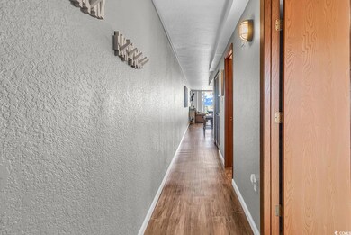Hall with baseboards, wood finished floors, a text