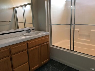 Master bathroom with double sinks, shower over tub.
