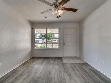 Spare room with a textured ceiling, ceiling fan, a