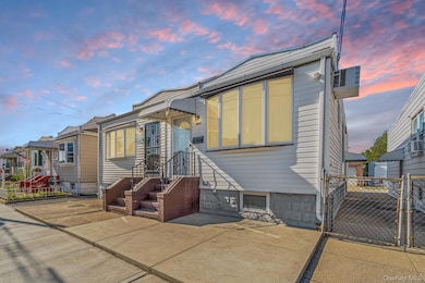 Back of property at dusk featuring a gate and a wall unit AC