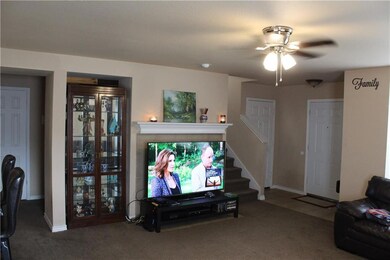 Electric fireplace behind TV