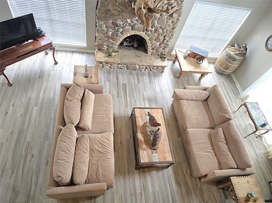 Spacious living room with a cozy stone fireplace,