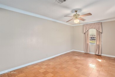Spare room with ceiling fan and ornamental molding