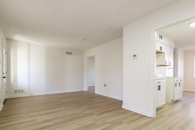 Empty room featuring light hardwood / wood-style f