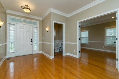 Spacious entrance foyer with gleaming hardwood floors...