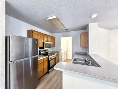 Kitchen with brown cabinets, light wood finished 