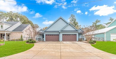 View of front of home featuring fence, driveway, a