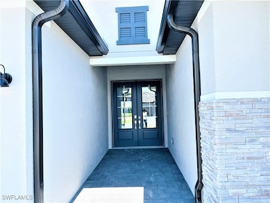 Property entrance with french doors and stucco sid