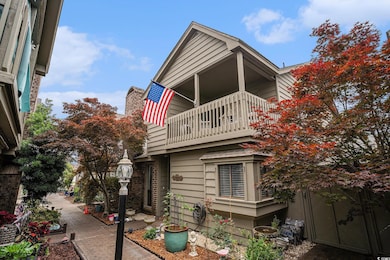 View of side of property with a balcony and a chimney