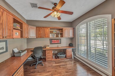 STUDY - is located to the right of the foyer through French doors and features a custom built-in work station.