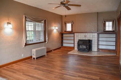 Spacious living room features a woodburner framed 