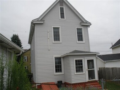 Enclosed back porch. Newer siding and windows.