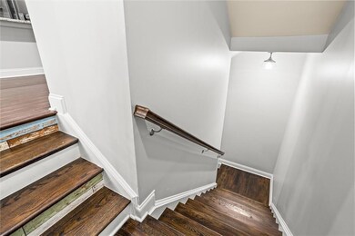 Stairs featuring wood finished floors and baseboards