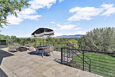 View of patio featuring a wooded view and an outdoor fire pit