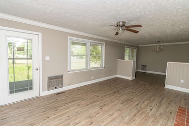 Empty room with ornamental molding, ceiling fan wi
