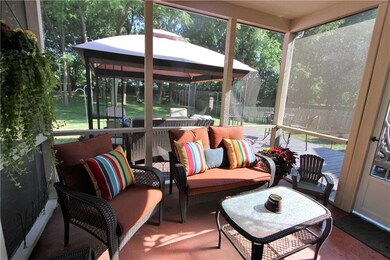 Sip your morning coffee on this lovely screened in porch.