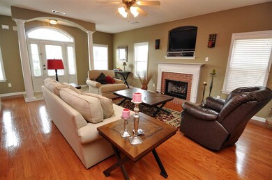 A cozy gas log fireplace with arched TV niche high