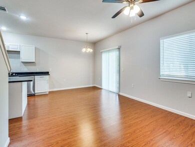 Kitchen with decorative light fixtures, ceiling fa