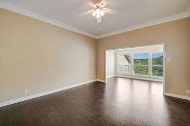 Spare room with crown molding, ceiling fan, and d