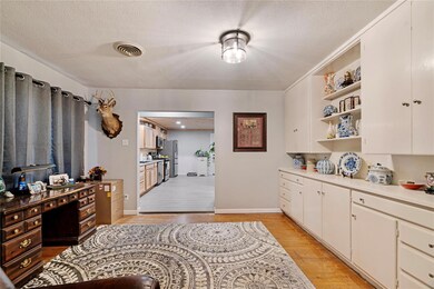 Kitchen featuring white cabinetry, stainless steel