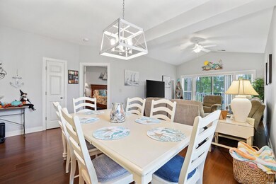 Dining room with dark wood-type flooring, ceiling 