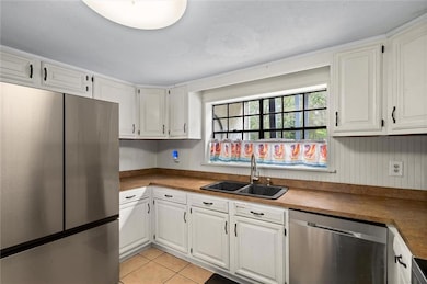 Kitchen with white cabinets and stainless steel ap