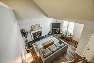 Living Room with vaulted ceiling,  LVT flooring, a